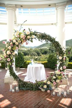 an outdoor ceremony setup with flowers and candles