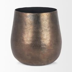 a large metal cup sitting on top of a white table