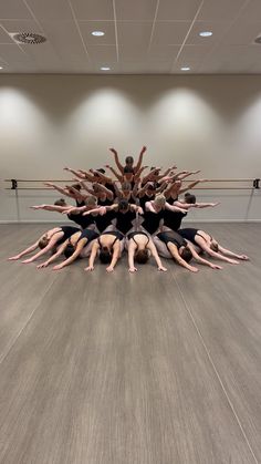 a group of people standing in a circle on top of each other