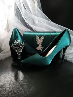 Elevate your evening ensemble with these exquisite Forest Green Satin Evening Shoes. Perfect for a Gothic Wedding, these stunning heels are a must-have for any bride or bridesmaid looking to make a statement. The carved detailing adds a touch of elegance, while the matching clutch bag ensures a coordinated and polished look for any formal event. Step out in style and grace with these luxurious heels and clutch set that are sure to turn heads and make you stand out from the crowd. Specifications: Elegant Green Wedding Shoes For Formal Occasion, Luxurious Heels, Wedding Heels For Bride, Emerald Green Heels, Heels For Bride, Shoes Gothic, Shoes Board, Stunning Heels, Green Heels