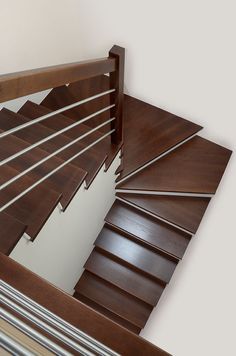 a wooden stair case with metal handrails