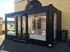 a black and white display case sitting on the side of a building