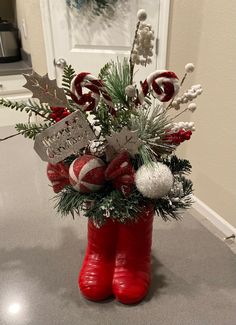 a red boot filled with candy canes and christmas decorations