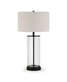 a glass table lamp with a white shade on the base and a black metal frame