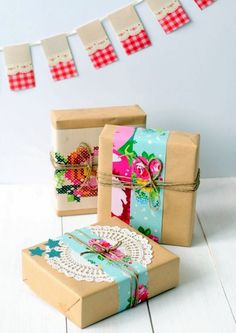 three gift boxes tied with twine and decorated with flowers