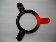 a black and red object on a white surface