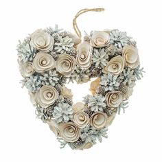 a heart shaped wreath with flowers and pine cones on the front, hanging from a rope