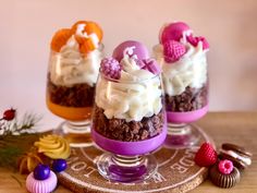 three desserts in small glass dishes on a table