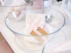 a glass bowl with some napkins in it