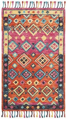 an orange, pink and blue rug with fringes on the bottom is shown in full view