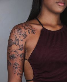 a woman with tattoos on her arm and shoulder