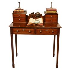 an antique desk with two books on it