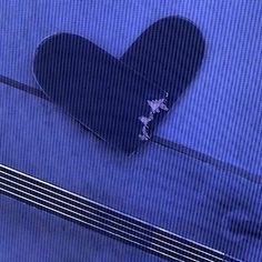 an acoustic guitar laying on top of a blue sheet