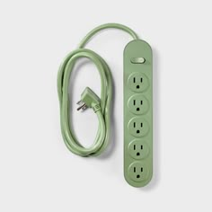 a green power strip sitting on top of a white wall