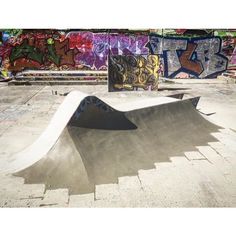 a skateboard park with graffiti on the walls