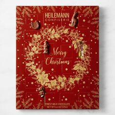 a red christmas card with gold foil and holly wreath on the front, surrounded by chocolate candies