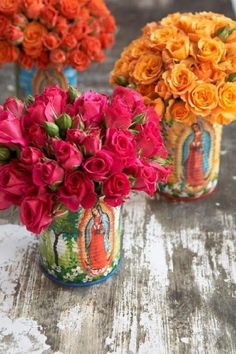 three vases filled with colorful flowers on top of a wooden table