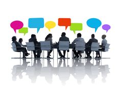 a group of people sitting at a table with speech bubbles above them