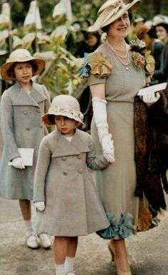 three women and two children are dressed in vintage clothing