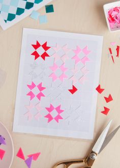 scissors and paper cut out to look like stars on a table with other crafting supplies