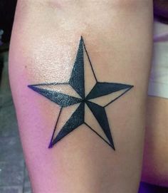 a black and white star tattoo on the leg