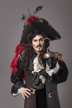 a man with long hair wearing a pirate costume