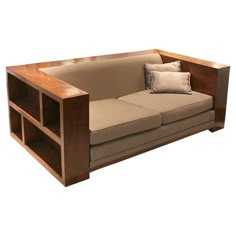 a couch with two pillows on it and a shelf in the middle that is made out of wood