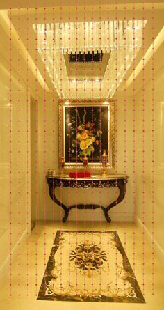 the hallway is decorated with beaded curtains and an ornate console table in front of a mirror