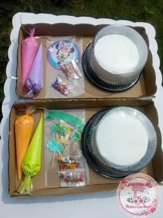 two cardboard boxes filled with cake and candy