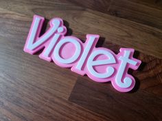 the word violet spelled in plastic letters on a wooden surface