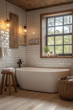 a white bath tub sitting under a window next to a wooden stool in a bathroom