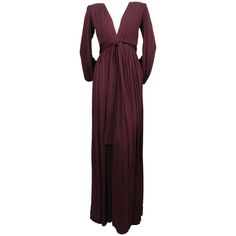 Exceptional, deep-plum jersey gown with deep V neckline, billowy sleeves and wrap belt from Yves Saint Laurent dating to the late 1970's. Labeled a French size 36". Approximate measurements: shoulders 14", bust 30-35", waist 23.75-24" (a tailor could let this out), arm length 27" and overall length 62". Wrap belt measures approximately : 89" long by 2.5" wide. Side zip entry and internal grosgrain ribbon waistband. Button closure at wrists. Made in France. Very good condition. 1970 Dress, Black Silk Top, Executive Woman, Wrap Belt, Couture Mode, Maxi Gown Dress, Gold Sequins, Silk Top, Black Silk