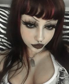 a woman with red hair and black makeup