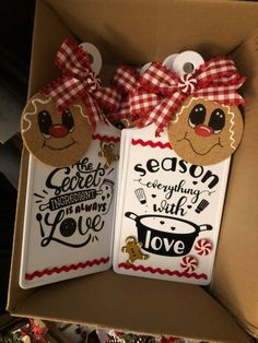 two decorated christmas tags in a box