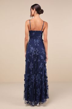 The Lulus Rare Presence Navy Blue 3D Floral Surplice Maxi Dress is the perfect look to celebrate any grand occasion! This elegant dress boasts a sheer mesh overlay, adorned with tonal floral embroidery and floral applique details (some of which have a 3D effect to them), that shapes a flattering princess-seamed bodice, a flirty surplice neckline, and adjustable spaghetti straps. The high, fitted waist sits atop a flowy, A-line skirt that cascades down to a sweeping maxi hem with an alluring side slit. Hidden back zipper/clasp. Fit: This garment fits true to size. Length: Floor length. Size medium measures 55" from adjustable straps to hem. Bust: Great for any cup size. Waist: Fitted - very fitted at natural waist. Hip: Not Fitted - fuller skirt allows room for hips. Undergarments: May be w Blue Beaded Bridesmaid Dress, Navy Floral Bridesmaid Dresses, Formal Dress Navy, Prom Dress Inspo Sparkly, Dark Blue Wedding Guest Dress, Blue Flowy Maxi Dress, Dreamy Prom Dress, Formal Dresses Flowy, Prom Dress 2025