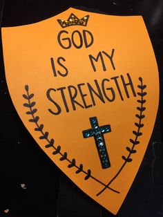 a yellow sign that says god is my strength with a cross and crown on it