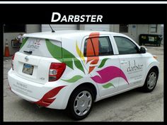 a white car with colorful flowers painted on it