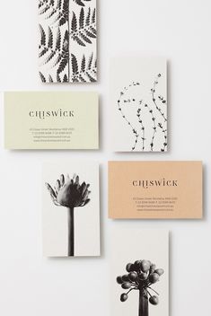 four cards with black and white flowers on them