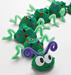 the paper mache caterpillars are green and purple