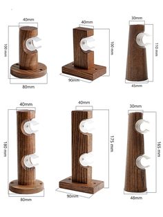 four different types of toilet paper dispensers on wooden bases with measurements for each one