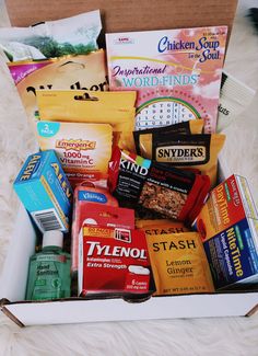 an open box filled with snacks sitting on top of a white furnishing floor