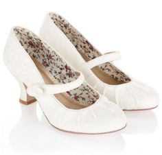 a pair of white shoes with floral print on the front and heel, in an advert