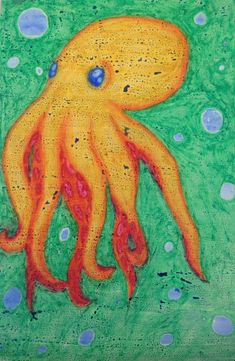 an octopus painting on green paper with blue dots and water droplets around it's head