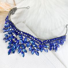 Add A Touch Of Elegance To Your Wedding Day Look With This Stunning Dark Blue Gemstone Wedding Tiara Headband. The Handmade Crown Features Intricate Blue Rhinestone Leaf Details That Will Complement Any Bridal Outfit. Perfect For A Bride Or Bridesmaid, This Tiara Headband Is A Must-Have For Any Formal Occasion. Made In The United States, This Crown Exudes Quality And Sophistication. Blue Tiara Wedding, Navy Blue Tiara, Bridal Tiara Blue, Crystal Headband For Wedding, Blue Crown Headpiece For Party, Dark Blue Tiara, Blue Party Crown Headpiece, Sapphire Wave Tiara, Wedding Tiara Headband