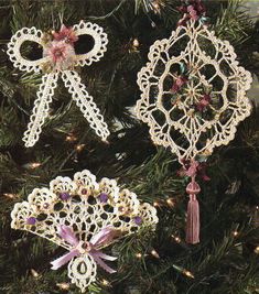 two crocheted ornaments hanging from a christmas tree