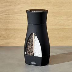 a black salt and pepper shaker sitting on top of a counter