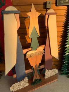 a group of christmas trees sitting on top of a wooden stand