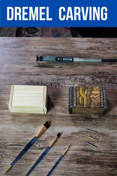 a wooden table topped with lots of different types of art supplies and tools on top of it