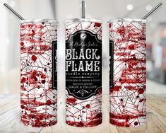 three red and white cans with black flame on them