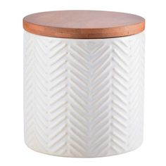 a white ceramic jar with wooden lid and chevron pattern on the front, sitting on a white background